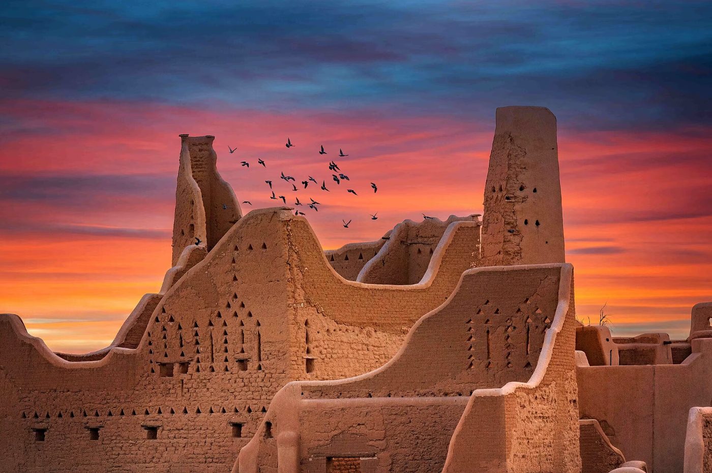The mud-brick towers of At-Turaif against a sunset sky